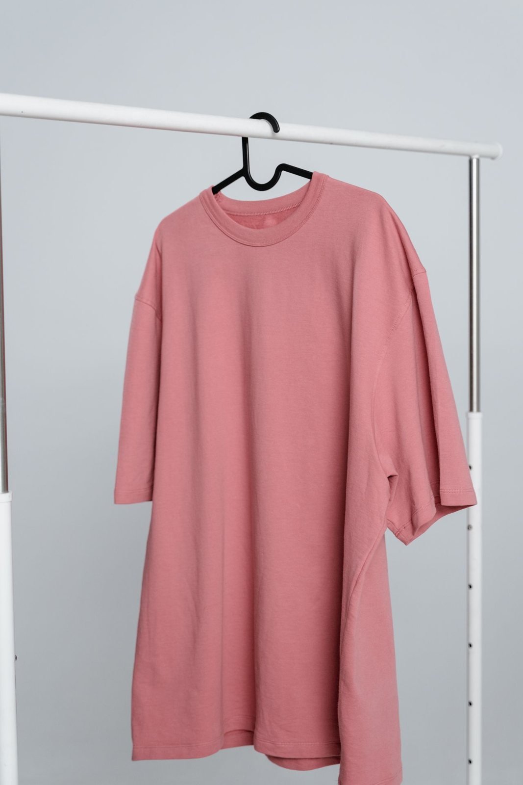 Original product photo: pink t-shirt on a hanger